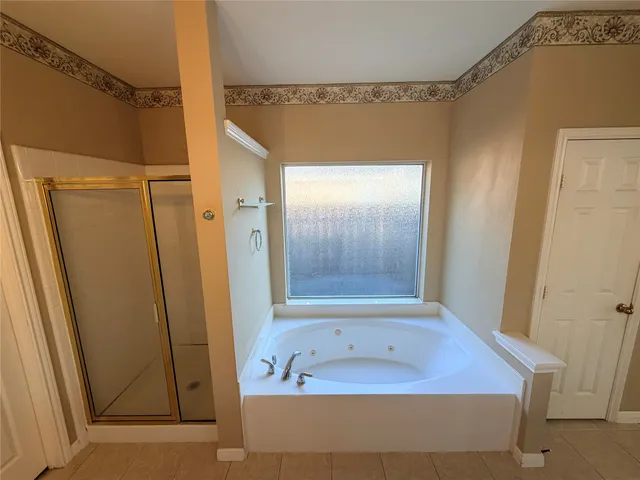 a bathroom with a tub and shower