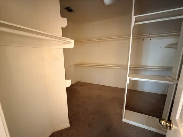 a view of closet with wooden floor