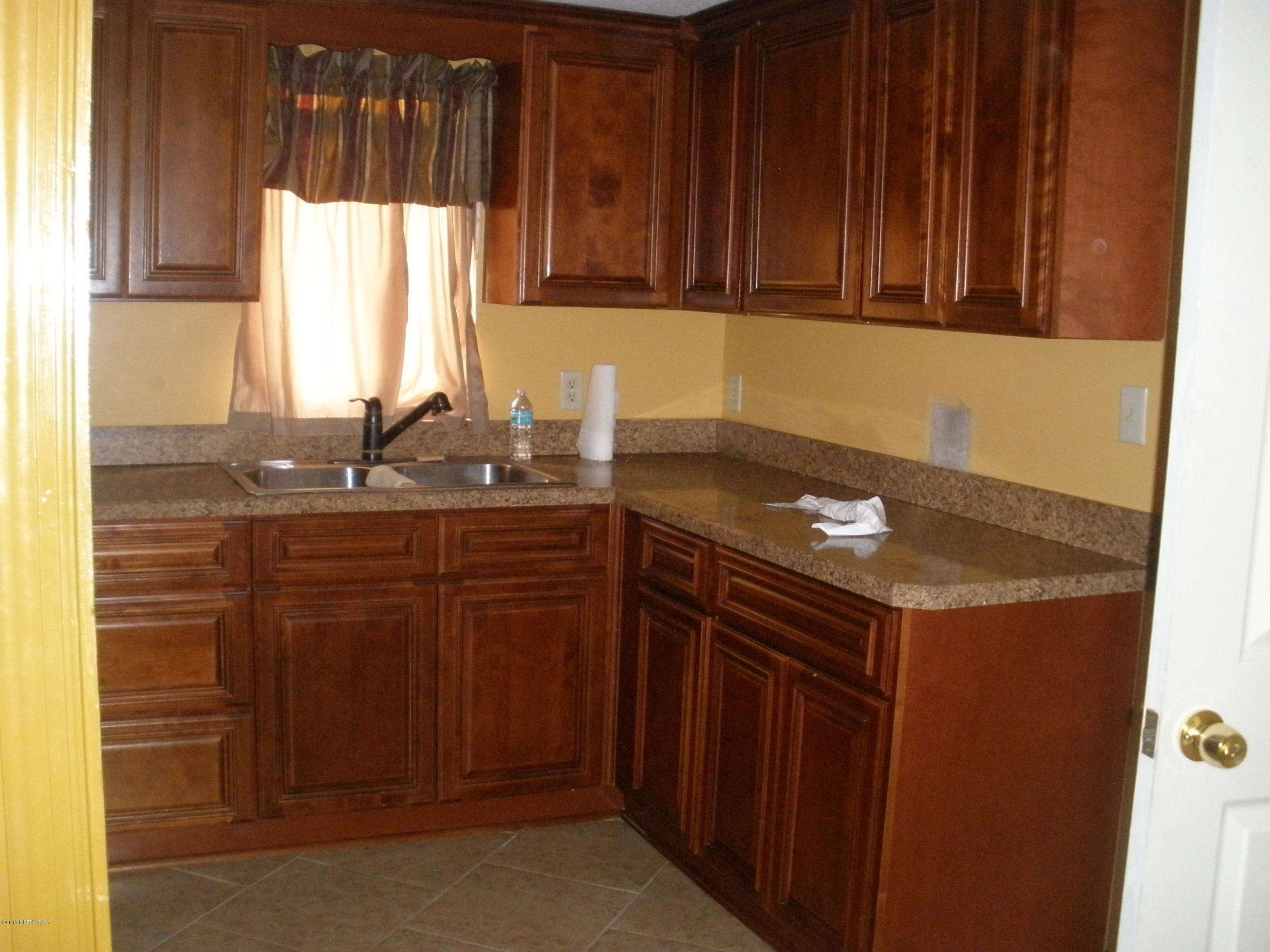220 Alvis Road Jacksonville, FL 32220 - Photo 3 of 18 a kitchen with a sink and cabinets