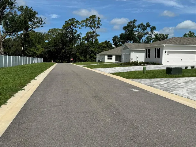 a view of a kitchen with cabinets and wooden floor
