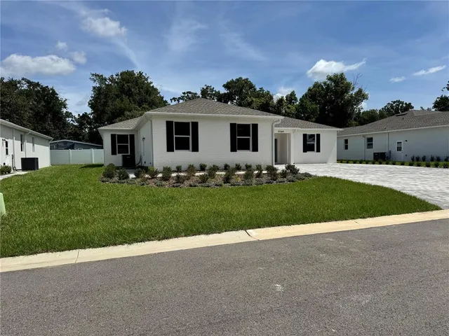 an empty room with wooden floor and mirror