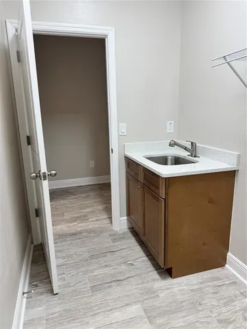 a view of kitchen with kitchen island stainless steel appliances a sink stove and refrigerator