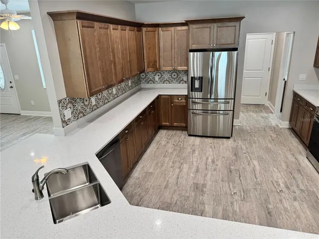 a kitchen with a sink stove and refrigerator