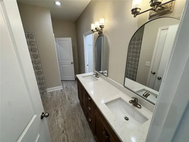 an aerial view of a house with swimming pool garden and patio