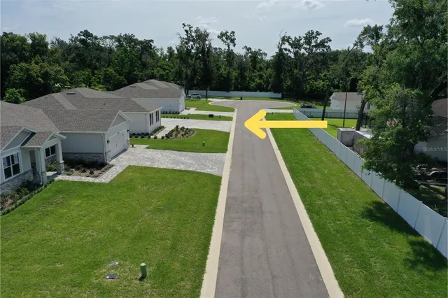 a white house with green field in front of it