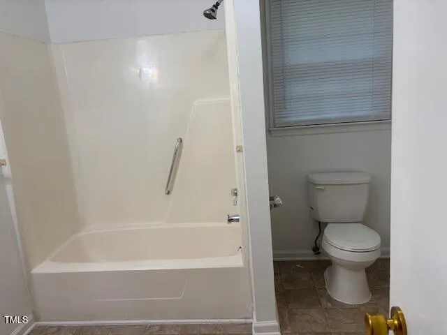 a bathroom with a toilet and a tub