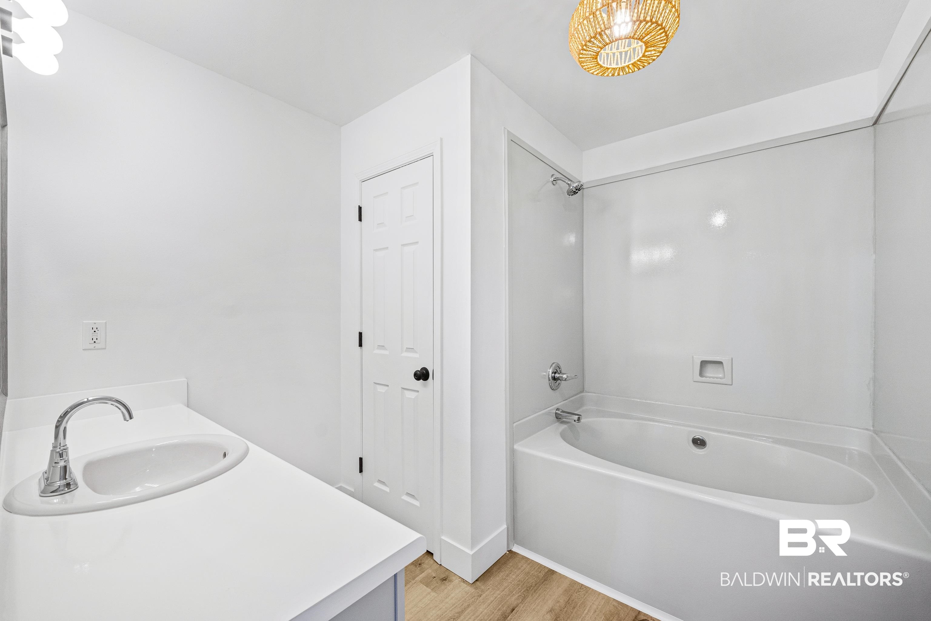9243 Brookshire Loop Daphne, AL 36526 - Photo 11 of 26 Bathroom featuring vanity, tub / shower combination, and hardwood / wood-style floors