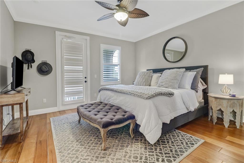 8028 Josefa Way Naples, FL 34114 - Photo 13 of 27 a bedroom with a bed and dresser with wooden floor
