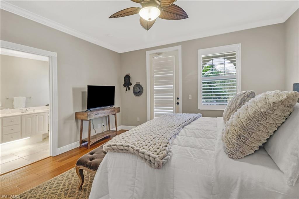8028 Josefa Way Naples, FL 34114 - Photo 14 of 27 a bedroom with a bed and a flat screen tv