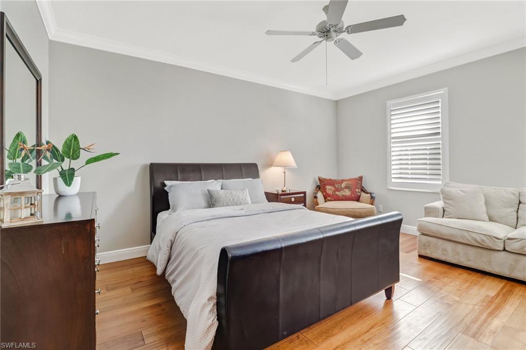 8028 Josefa Way Naples, FL 34114 - Photo 17 of 27 a bedroom with a bed and ceiling fan