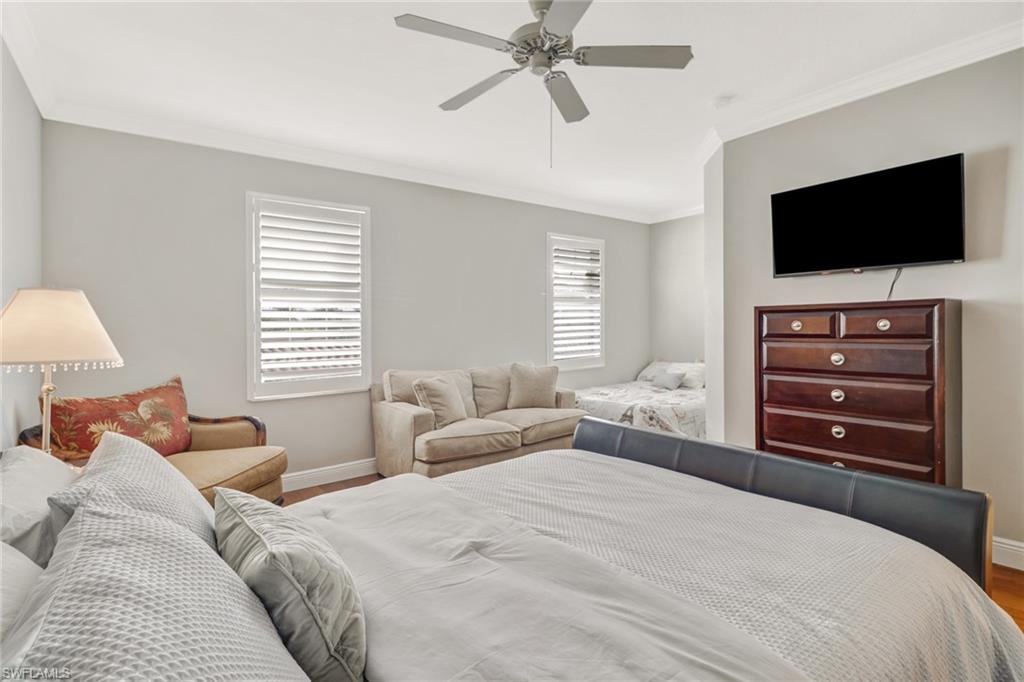 8028 Josefa Way Naples, FL 34114 - Photo 18 of 27 a bedroom with a bed and a flat screen tv