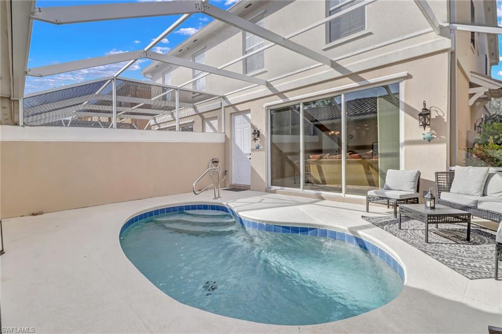 8028 Josefa Way Naples, FL 34114 - Photo 21 of 27 a view of a swimming pool with a lounge chair