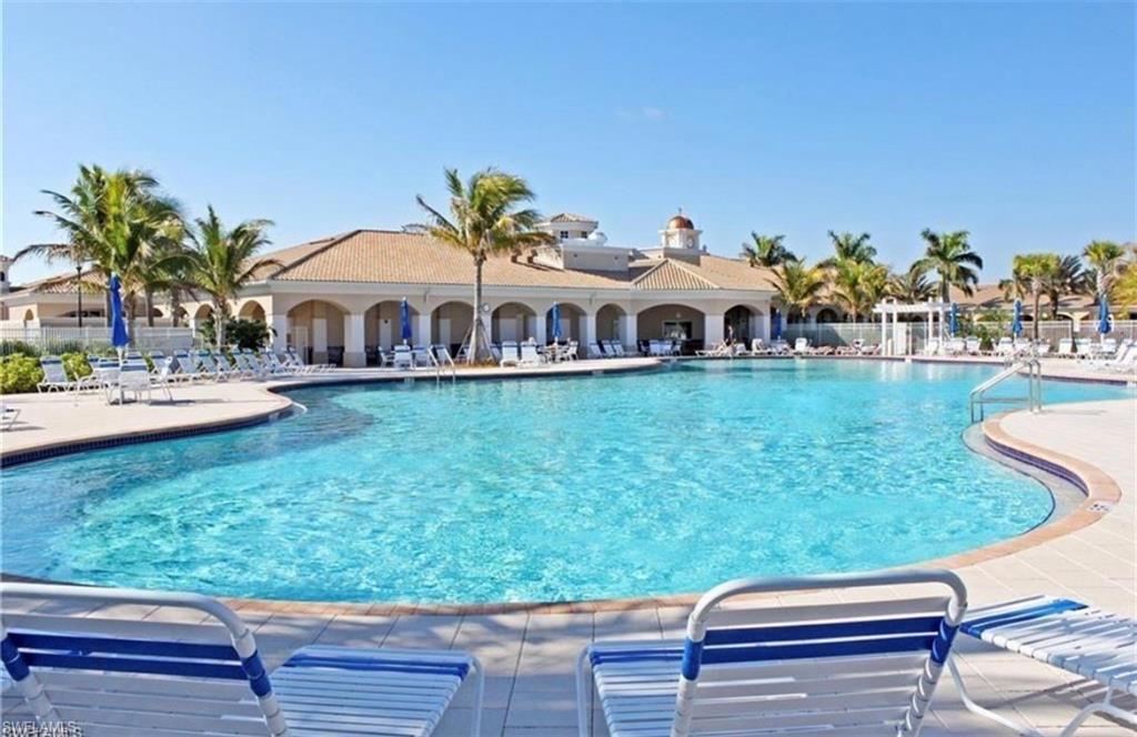 8028 Josefa Way Naples, FL 34114 - Photo 27 of 27 a view of a swimming pool with lawn chairs and plants