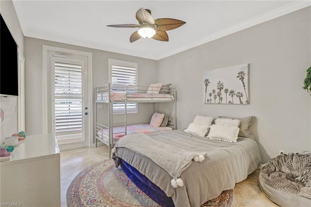 8028 Josefa Way Naples, FL 34114 - Photo 10 of 27 a bedroom with a bed and a chandelier