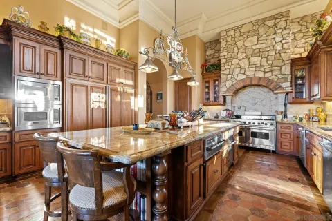 a kitchen with stainless steel appliances granite countertop a stove and cabinets