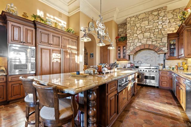 a kitchen with stainless steel appliances granite countertop a stove and cabinets