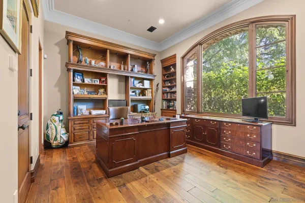 a room with wooden floor and furniture