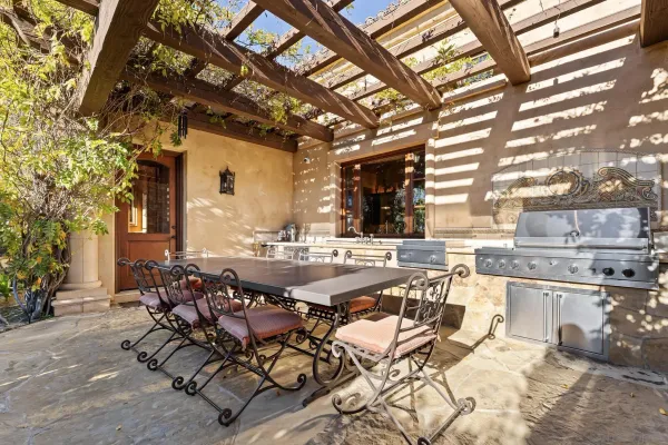 a building outdoor space with patio furniture and potted plants