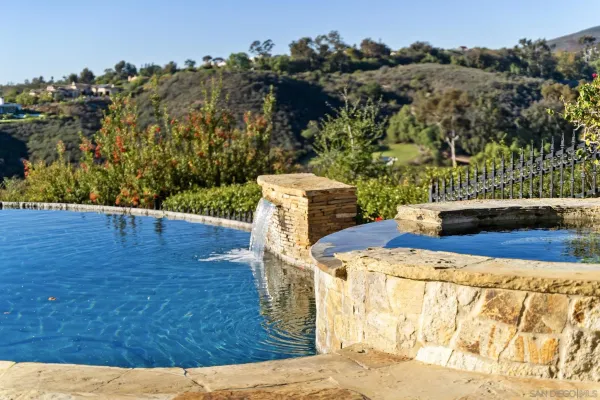 a front view of a house with swimming pool and porch