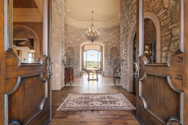 a view of a hallway with a dining table & chairs