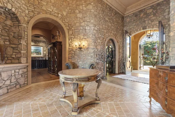 a view of a hallway with furniture and a fireplace