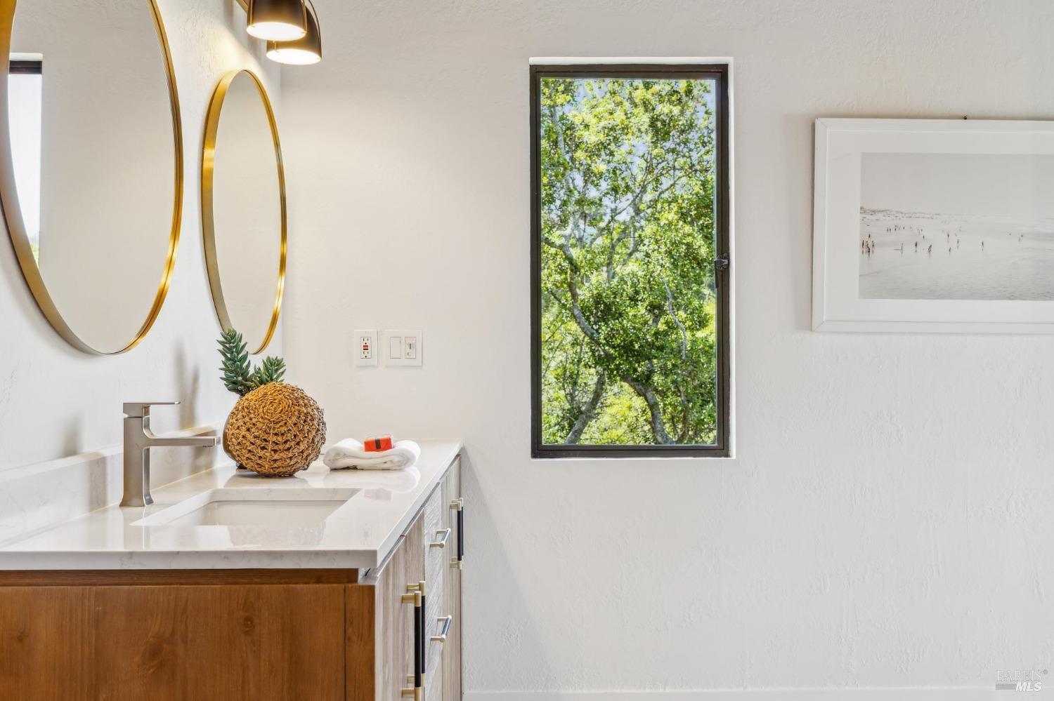 480 Live Oak Drive Mill Valley, CA 94941 - Photo 23 of 71 a bathroom with a granite countertop sink and a mirror