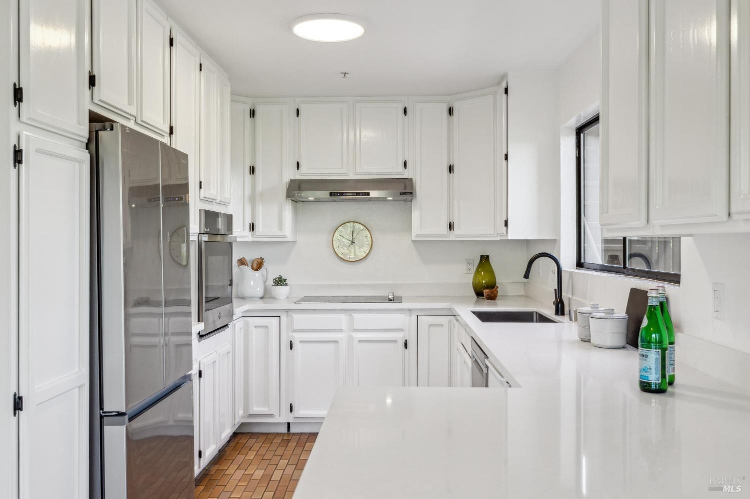 480 Live Oak Drive Mill Valley, CA 94941 - Photo 32 of 71 a kitchen with white cabinets and refrigerator