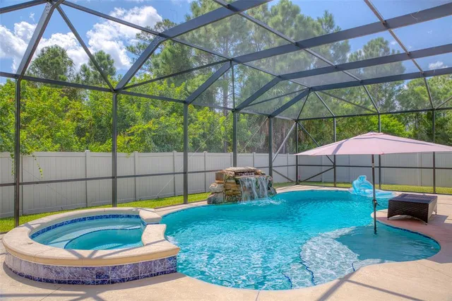 an aerial view of a house with swimming pool and big yard