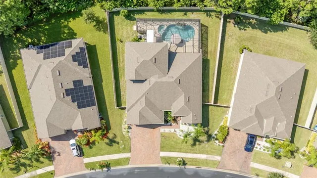 an aerial view of a house with a yard