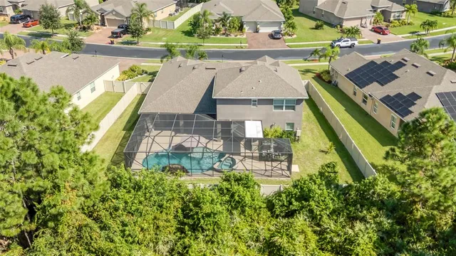 an aerial view of a house with a yard