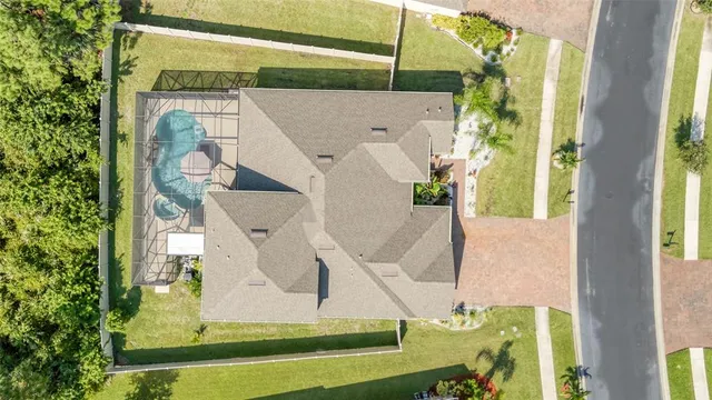 a front view of a house with a yard and potted plants