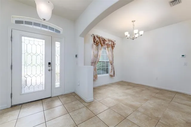 a view of a livingroom with wooden floor and a bathroom