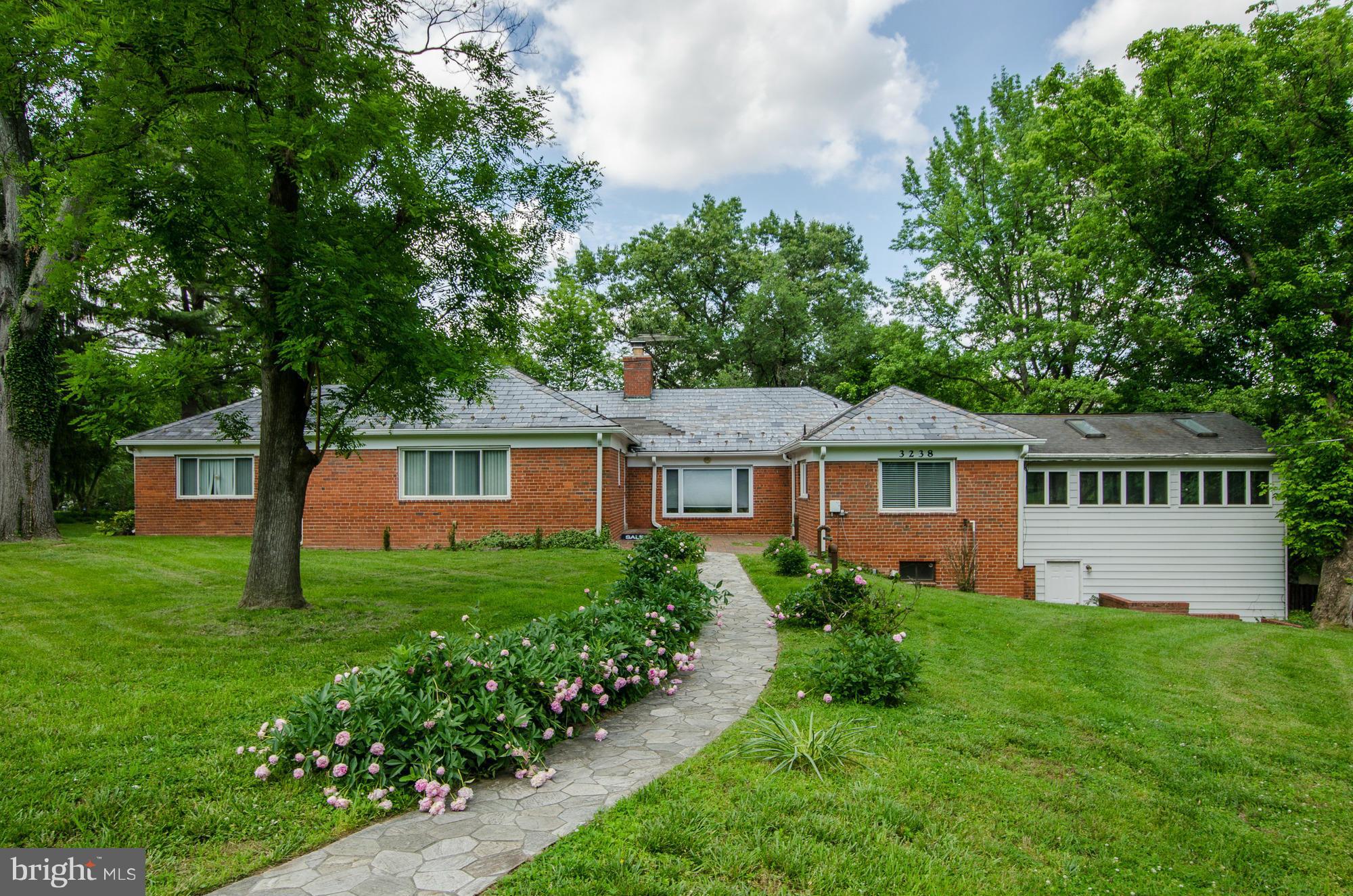 3238 Park View Road Chevy Chase, MD 20815 - Photo 1 of 28 a front view of a house with a yard and trees