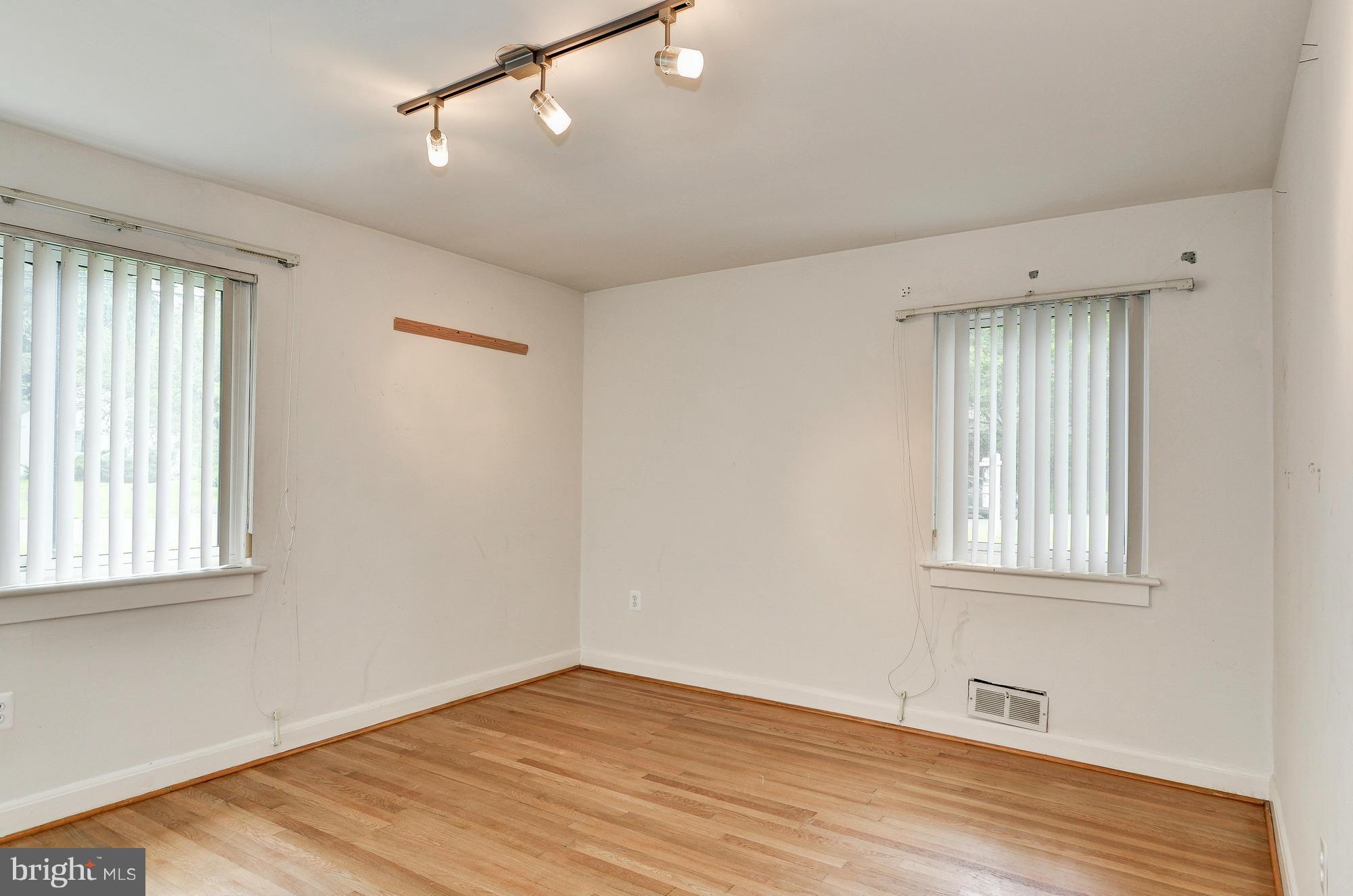 3238 Park View Road Chevy Chase, MD 20815 - Photo 14 of 28 an empty room with wooden floor and windows