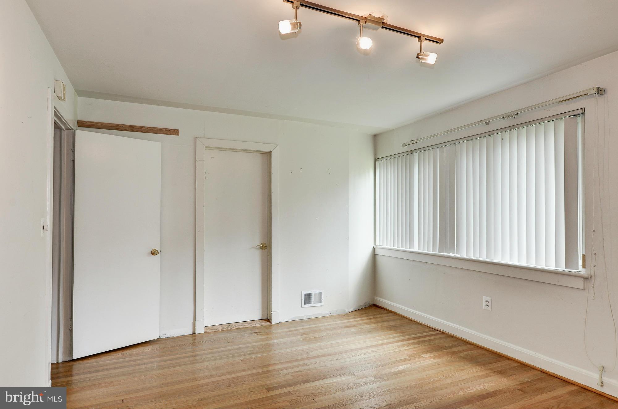3238 Park View Road Chevy Chase, MD 20815 - Photo 15 of 28 a view of an empty room with wooden floor and a window