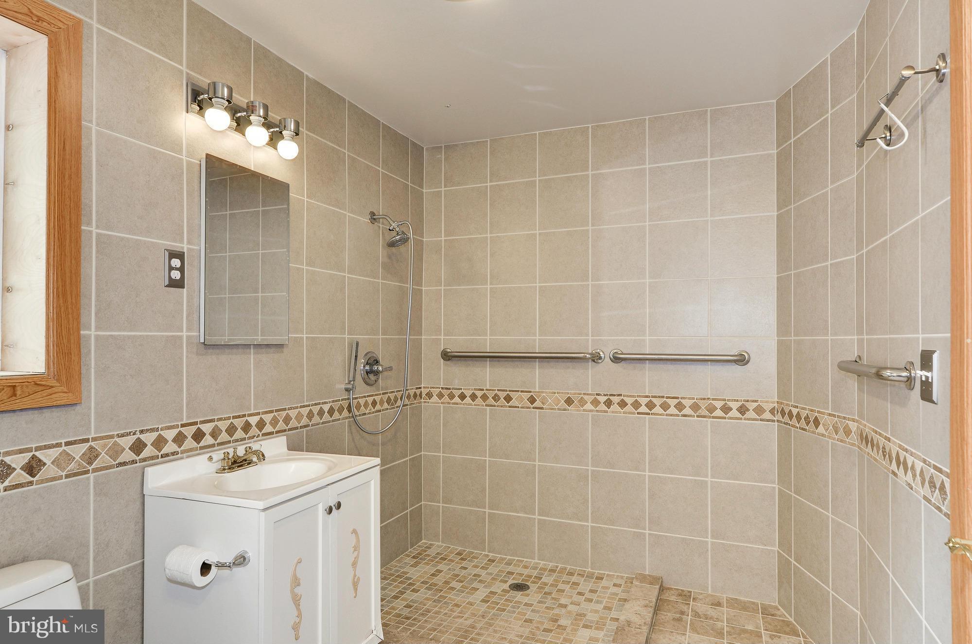 3238 Park View Road Chevy Chase, MD 20815 - Photo 16 of 28 a bathroom with a sink a toilet and shower