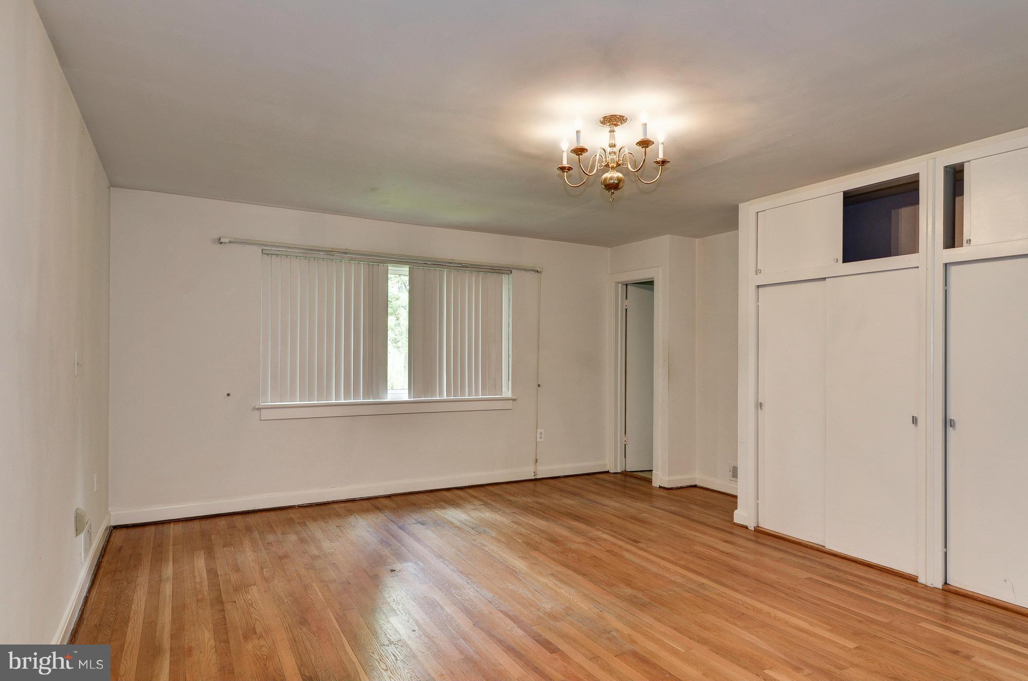 3238 Park View Road Chevy Chase, MD 20815 - Photo 18 of 28 a view of an empty room with a window and wooden floor