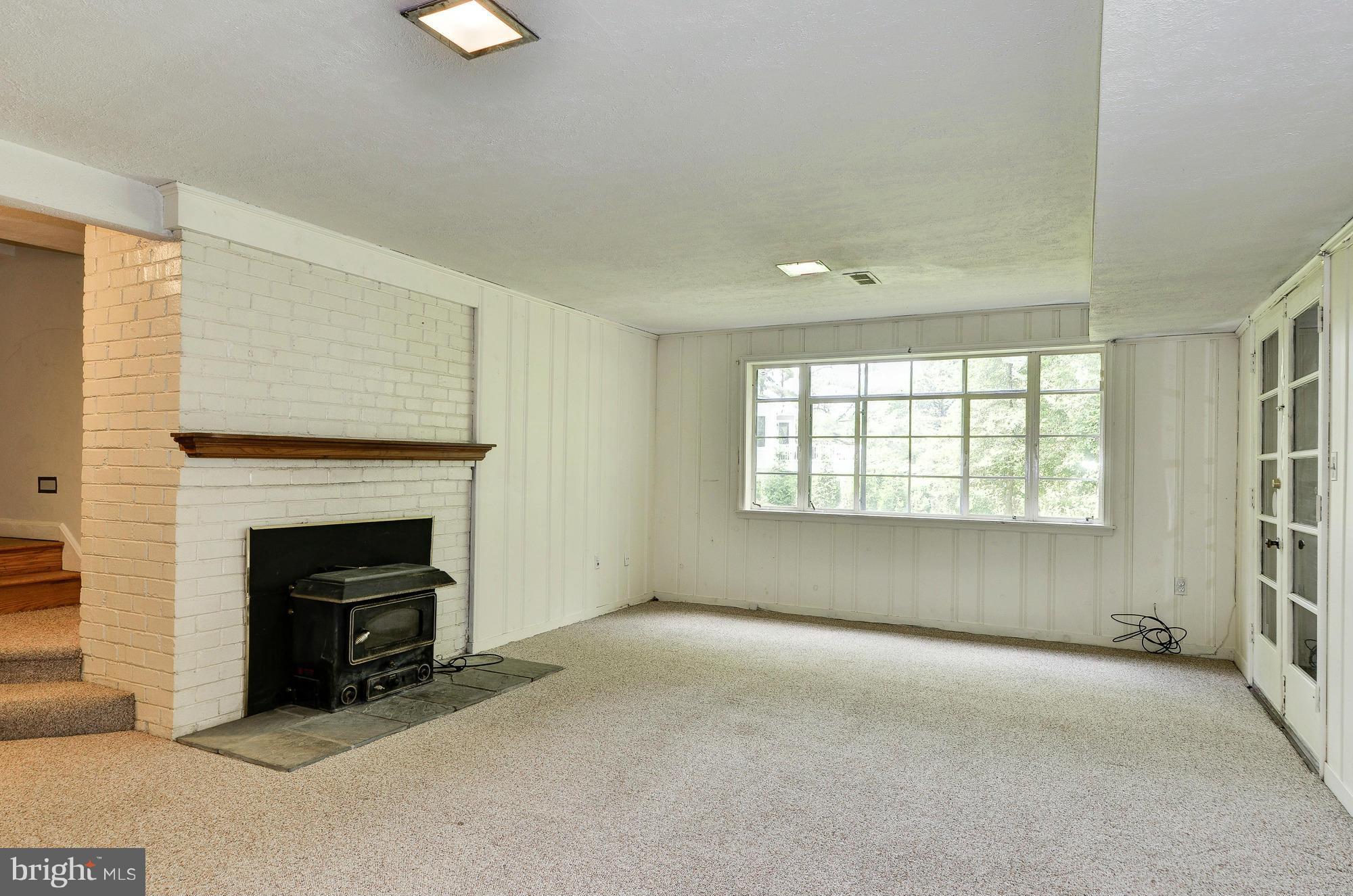 3238 Park View Road Chevy Chase, MD 20815 - Photo 20 of 28 an empty room with windows and fireplace