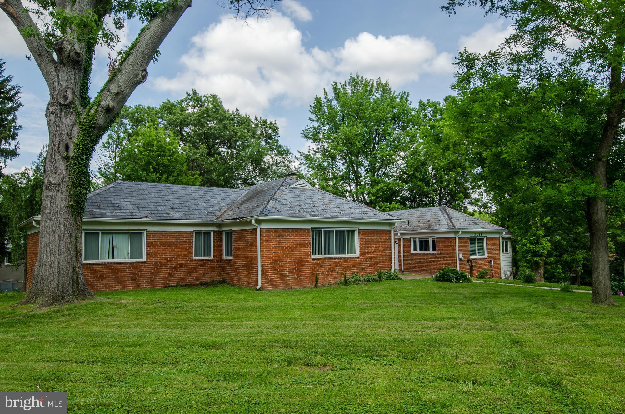 3238 Park View Road Chevy Chase, MD 20815 - Photo 24 of 28 a front view of a house with a garden