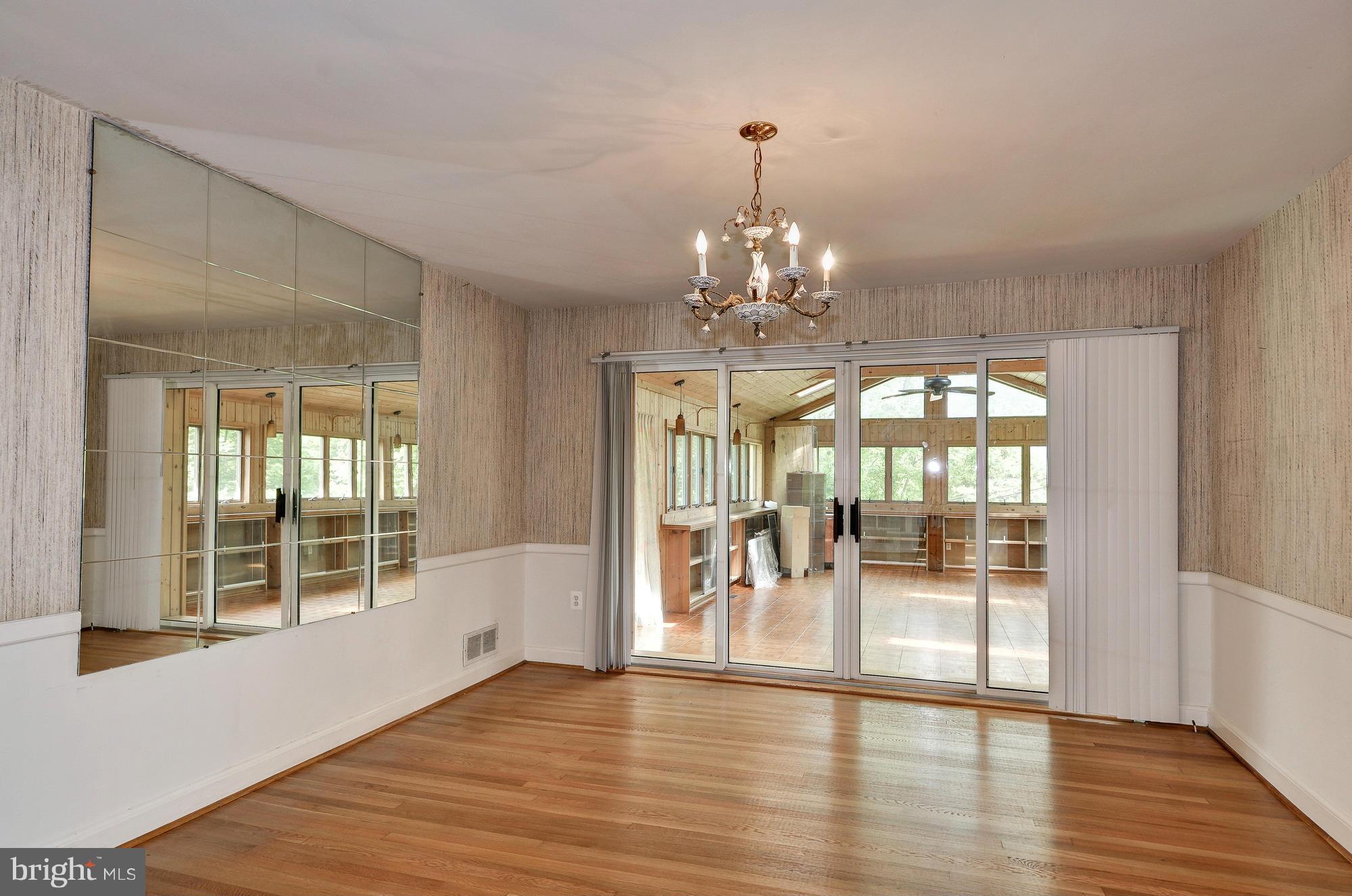 3238 Park View Road Chevy Chase, MD 20815 - Photo 5 of 28 a view of a room with wooden floor chandelier and windows