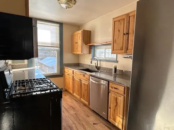 a kitchen with a stove a sink and a microwave