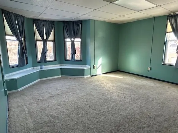 an empty room with windows and outdoor view