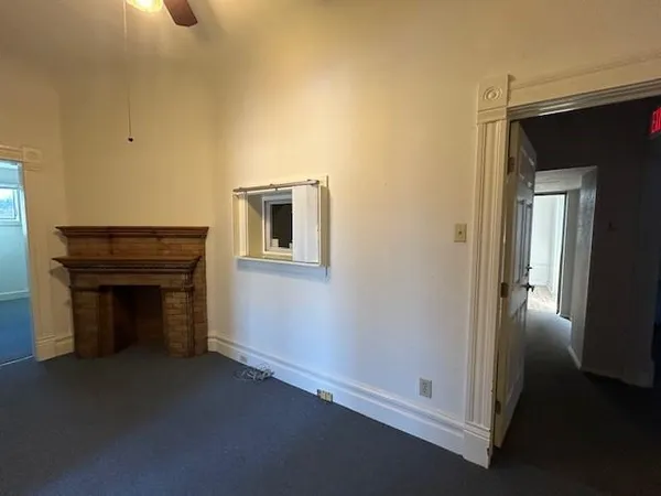 a view of empty room with front door and wooden floor