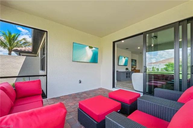 a living room with furniture and a floor to ceiling window