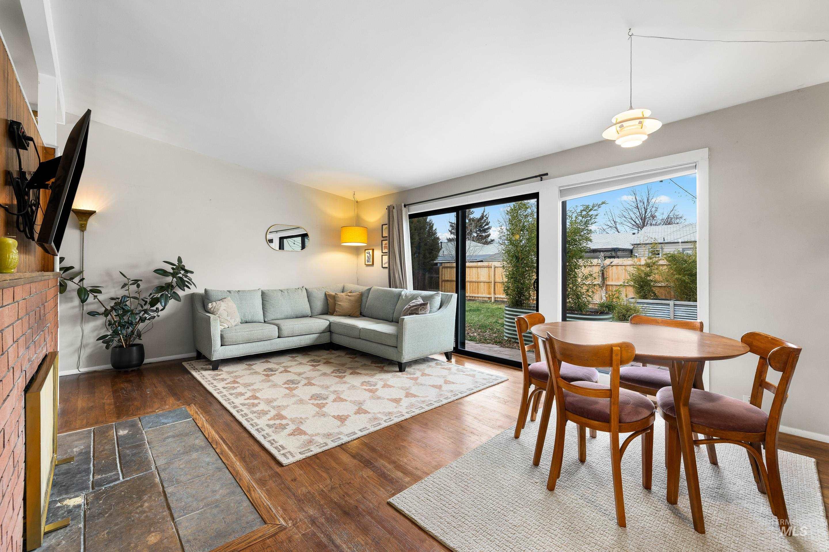2824 West Kathryn Street Boise, ID 83705 - Photo 14 of 40 Dining room featuring a fireplace and dark wood finished floors