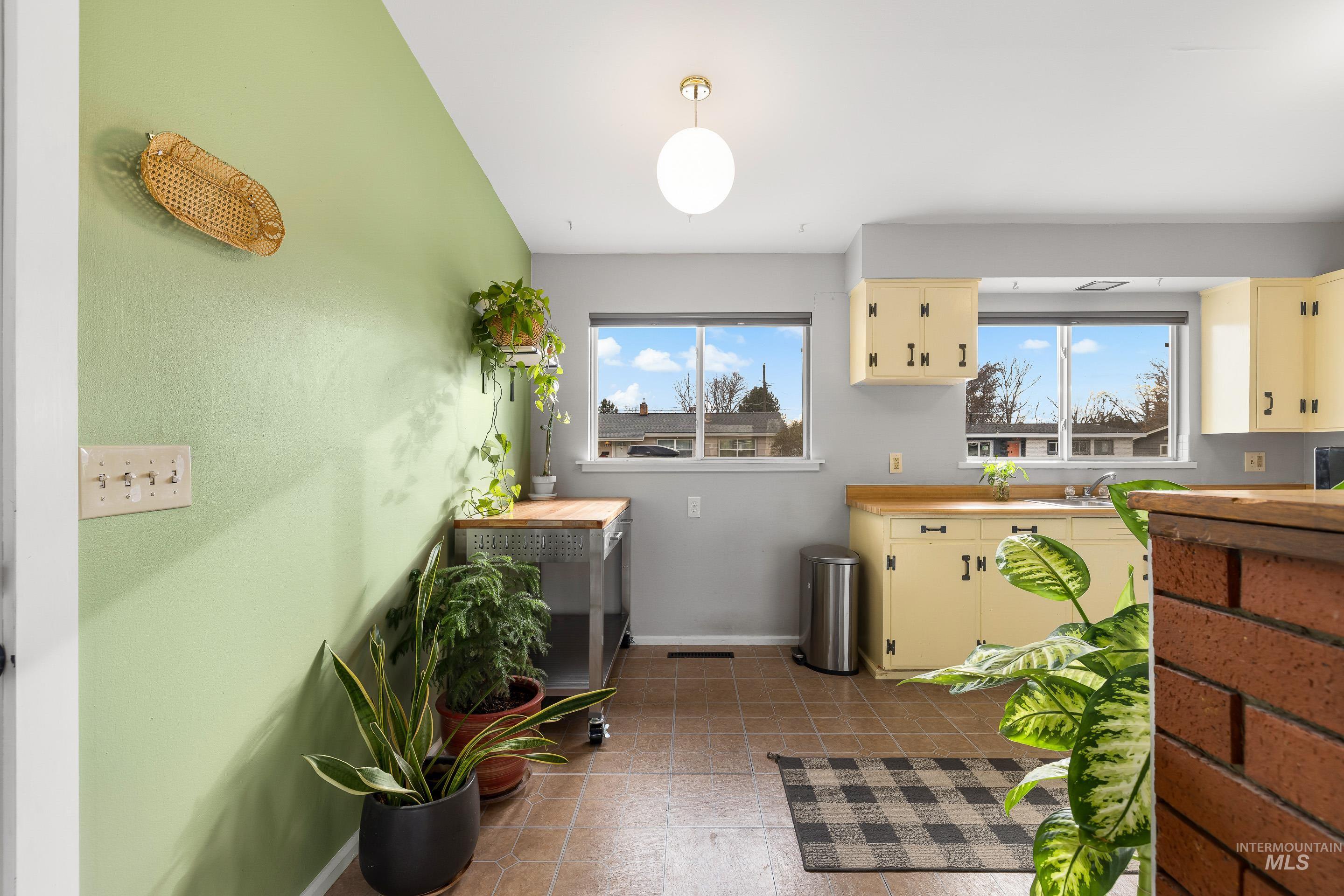 2824 West Kathryn Street Boise, ID 83705 - Photo 16 of 40 Kitchen with plenty of natural light, light countertops, hanging light fixtures, and cream cabinets
