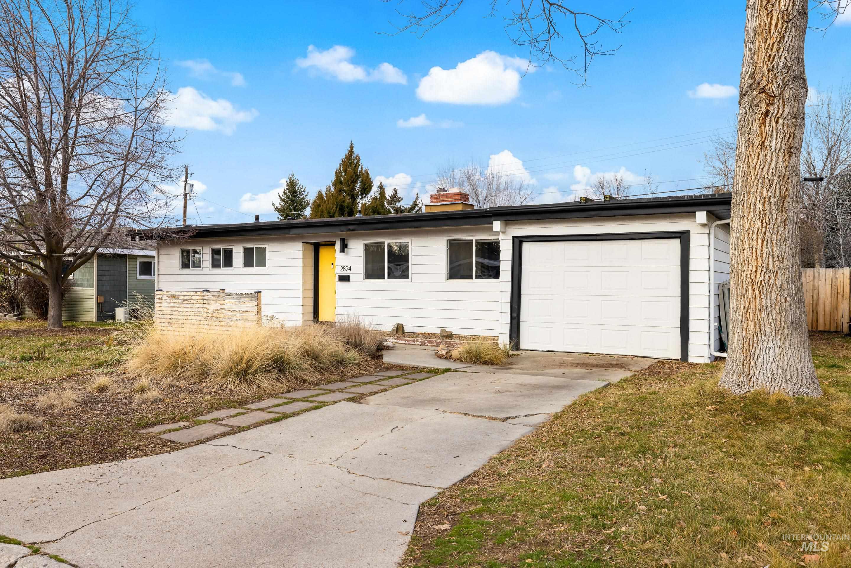 2824 West Kathryn Street Boise, ID 83705 - Photo 2 of 40 Ranch-style house featuring concrete driveway, a chimney, and a garage