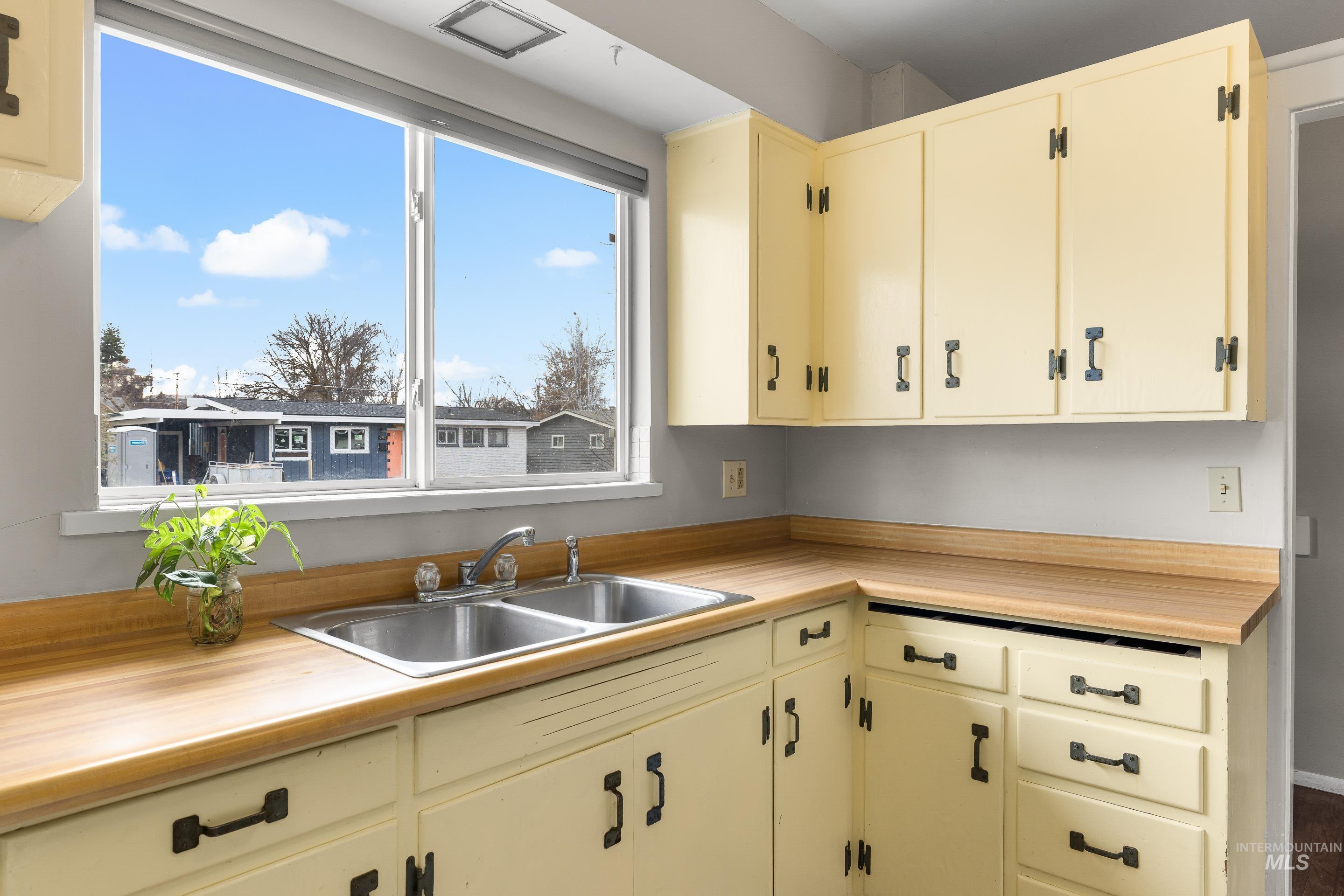 2824 West Kathryn Street Boise, ID 83705 - Photo 23 of 40 Kitchen featuring light countertops and cream cabinetry