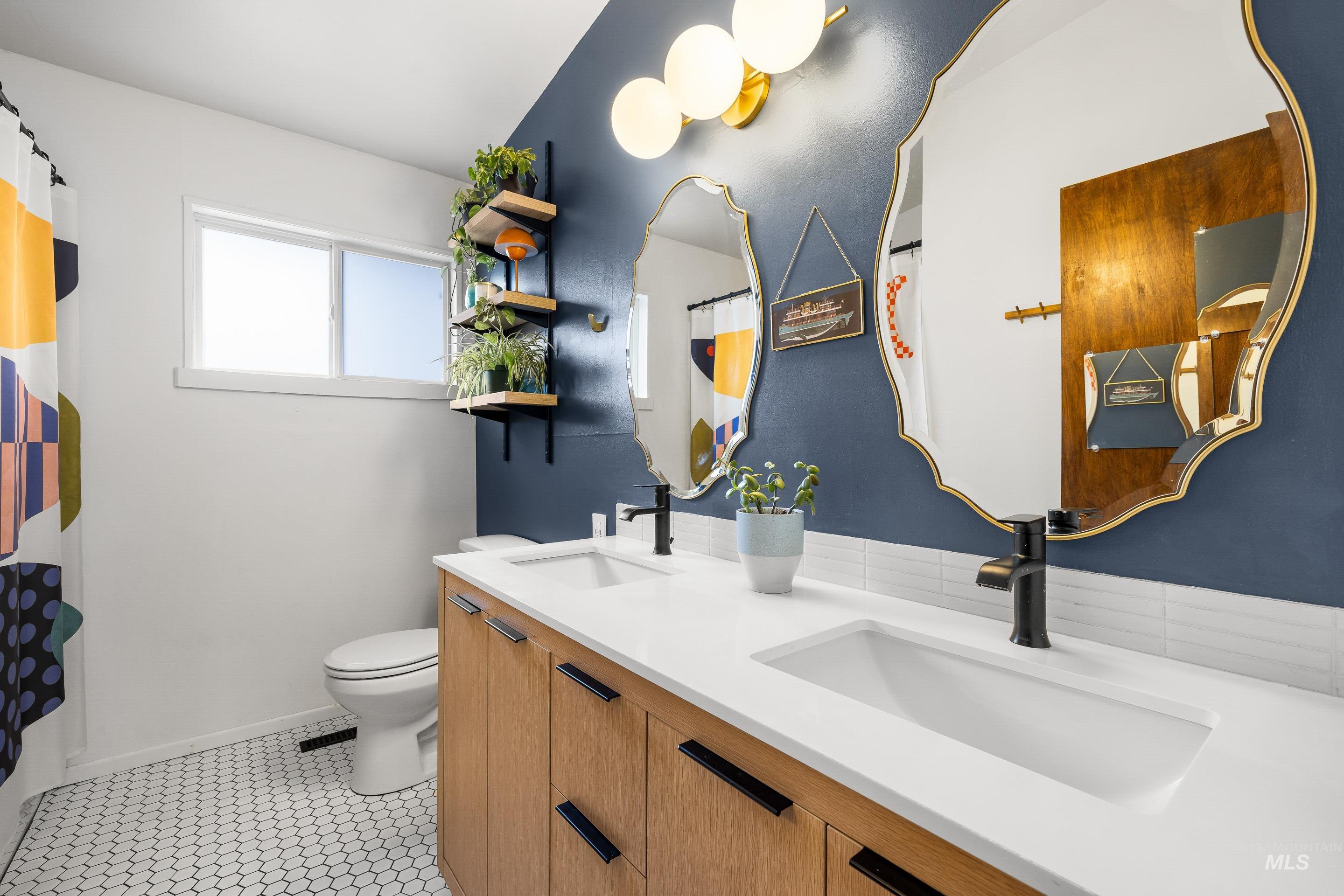 2824 West Kathryn Street Boise, ID 83705 - Photo 29 of 40 Bathroom with double vanity, a shower with curtain, and light tile patterned floors