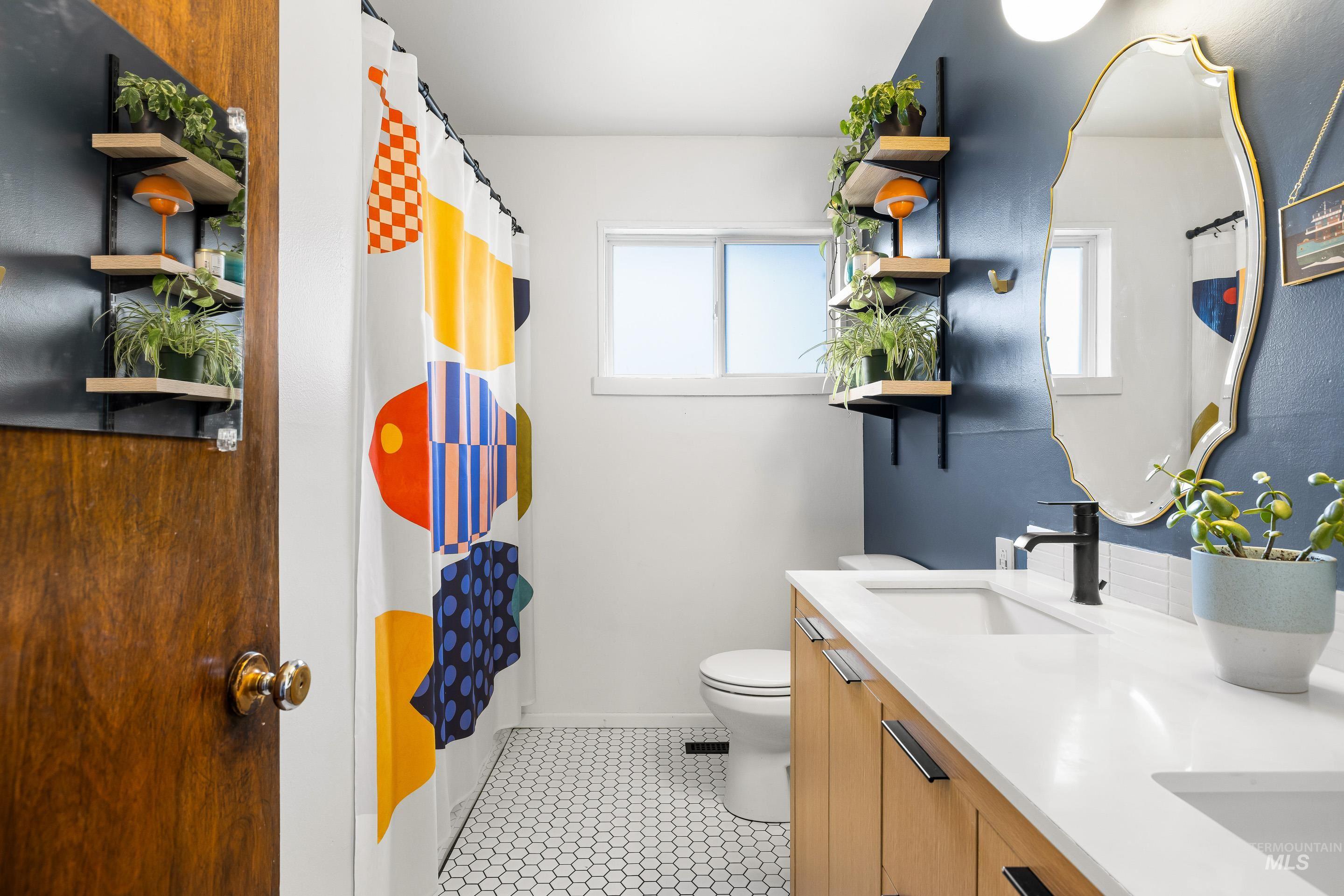 2824 West Kathryn Street Boise, ID 83705 - Photo 30 of 40 Bathroom with a shower with curtain, double vanity, and light tile patterned floors